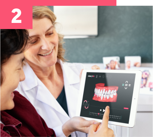 Un praticien en train de montrer un plan de traitement à son patient sur une tablette