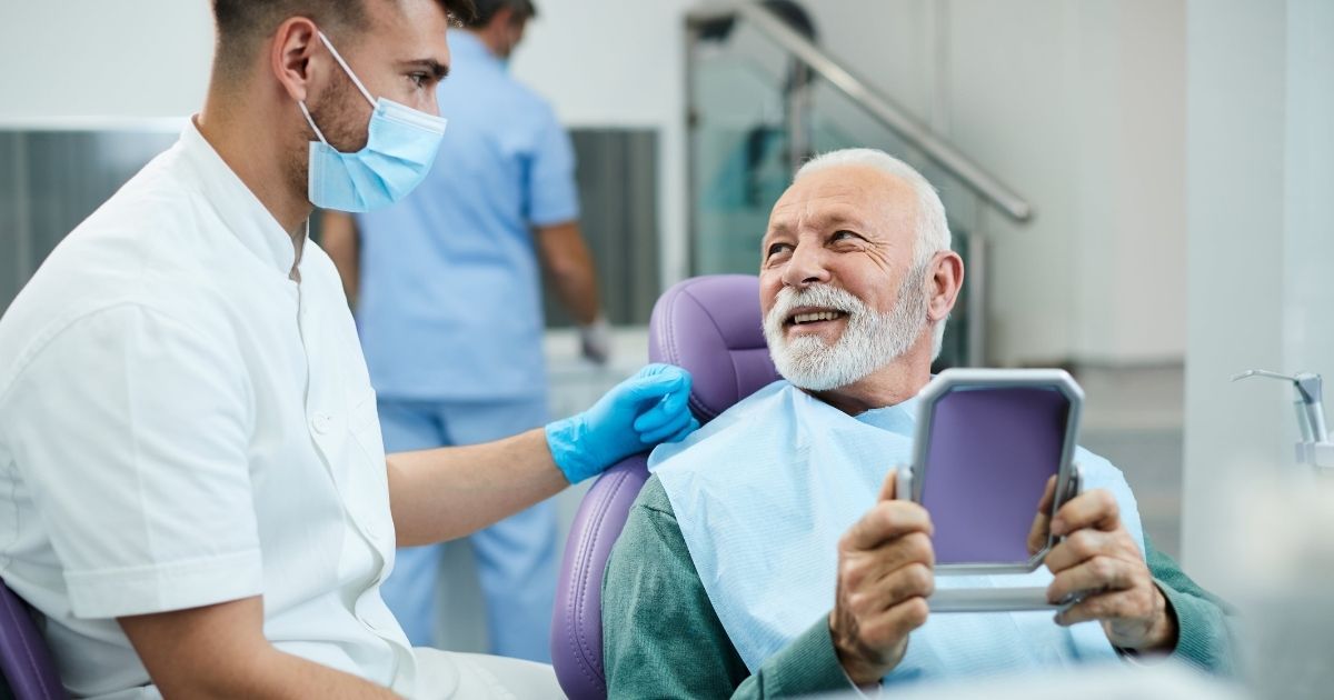 Dental patient choosing between dentures and dental implants at the dentist