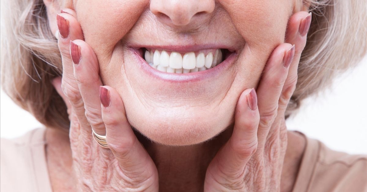 A woman with dentures smiling