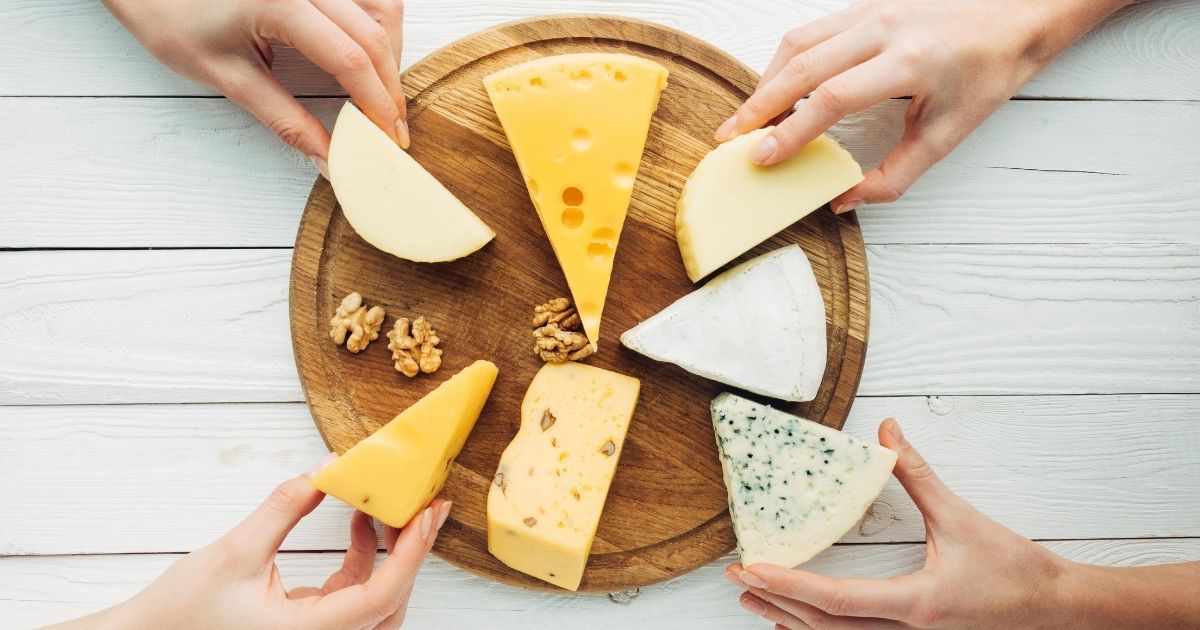 People enjoying cheese at a party - dental implants and dairy