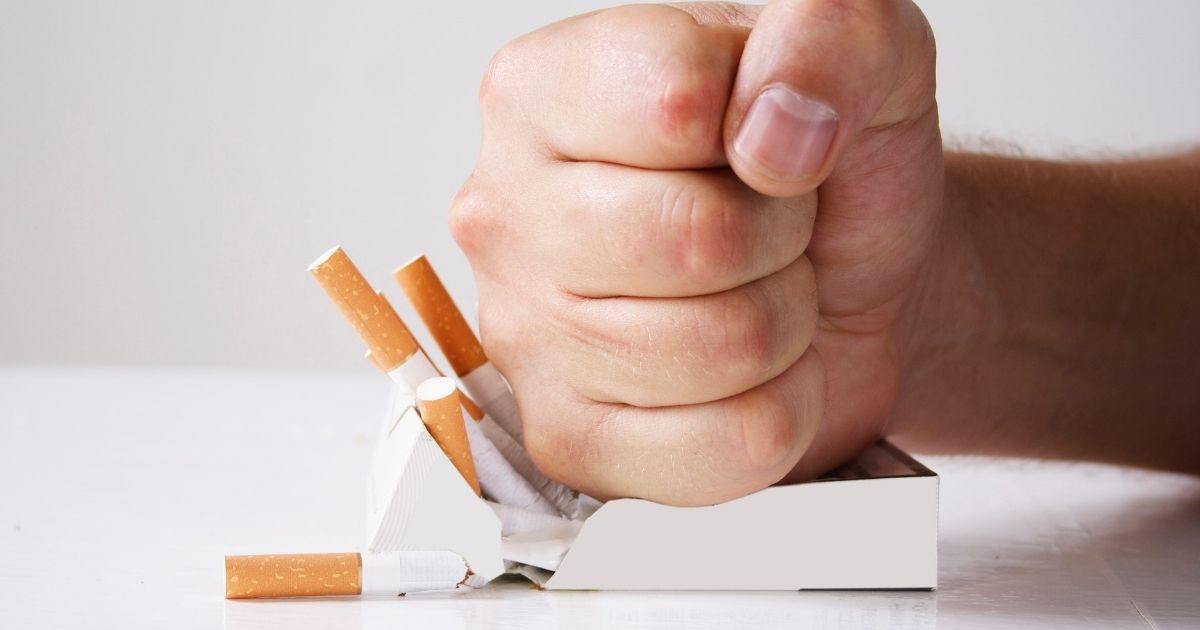 A smoker saying no to cigarettes before dental implant procedure