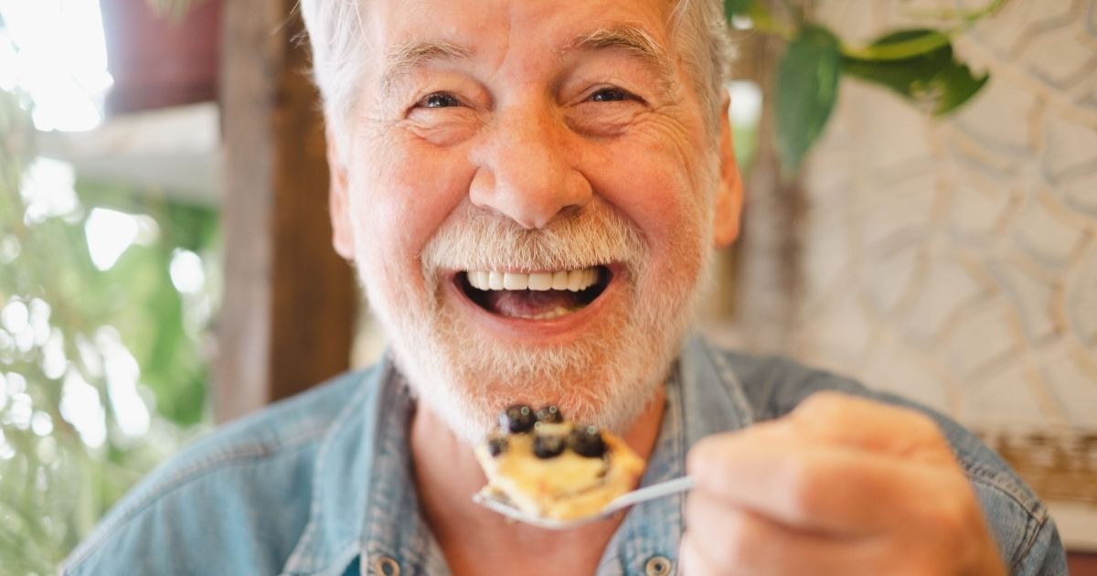 A man eating after a dental implant treatment