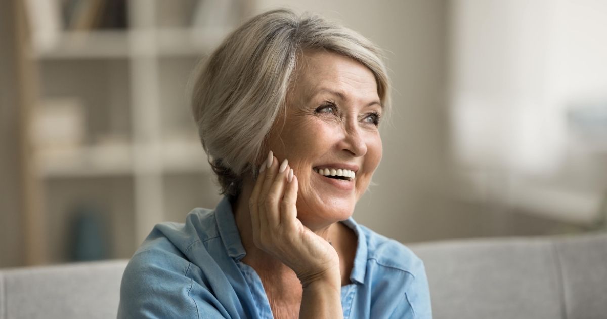 woman with dental implants checking how dental implants feel