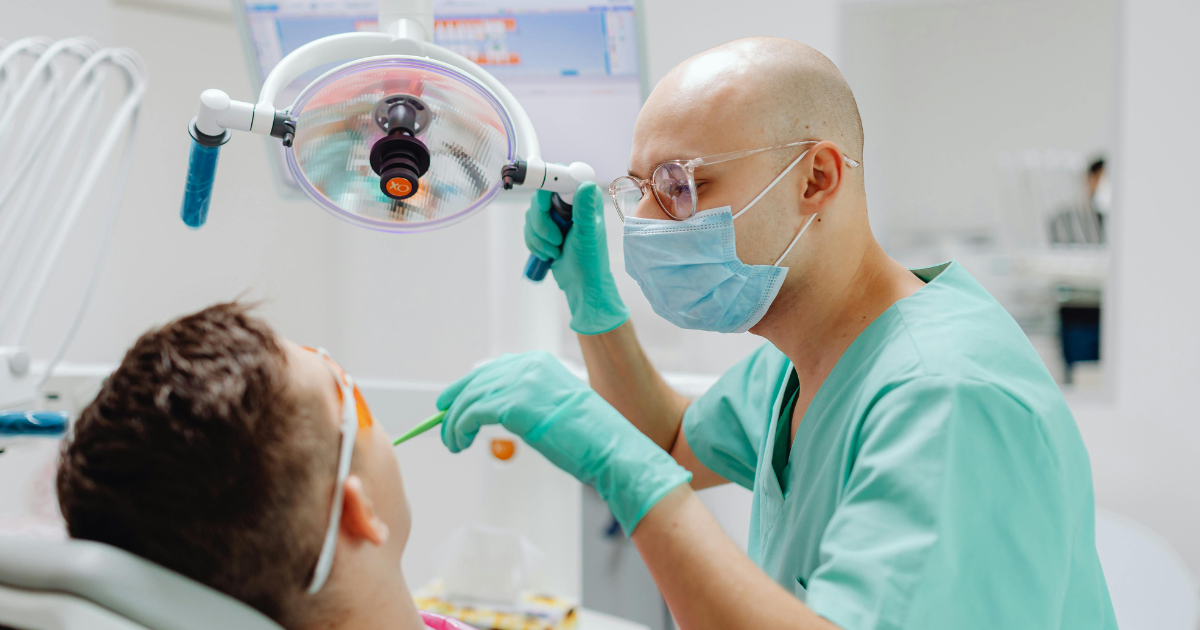 Dentist checking gum disease extent before evaluating for dental implants